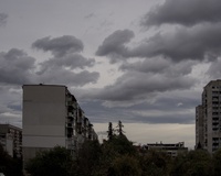 High-rise apartment buildings under a dark, stormy sky