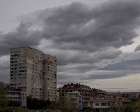 Overcast sky with scattered clouds above urban apartment buildings
