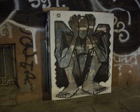 An electrical box decorated with a picture of a sitting human covering / holding their head with both hands